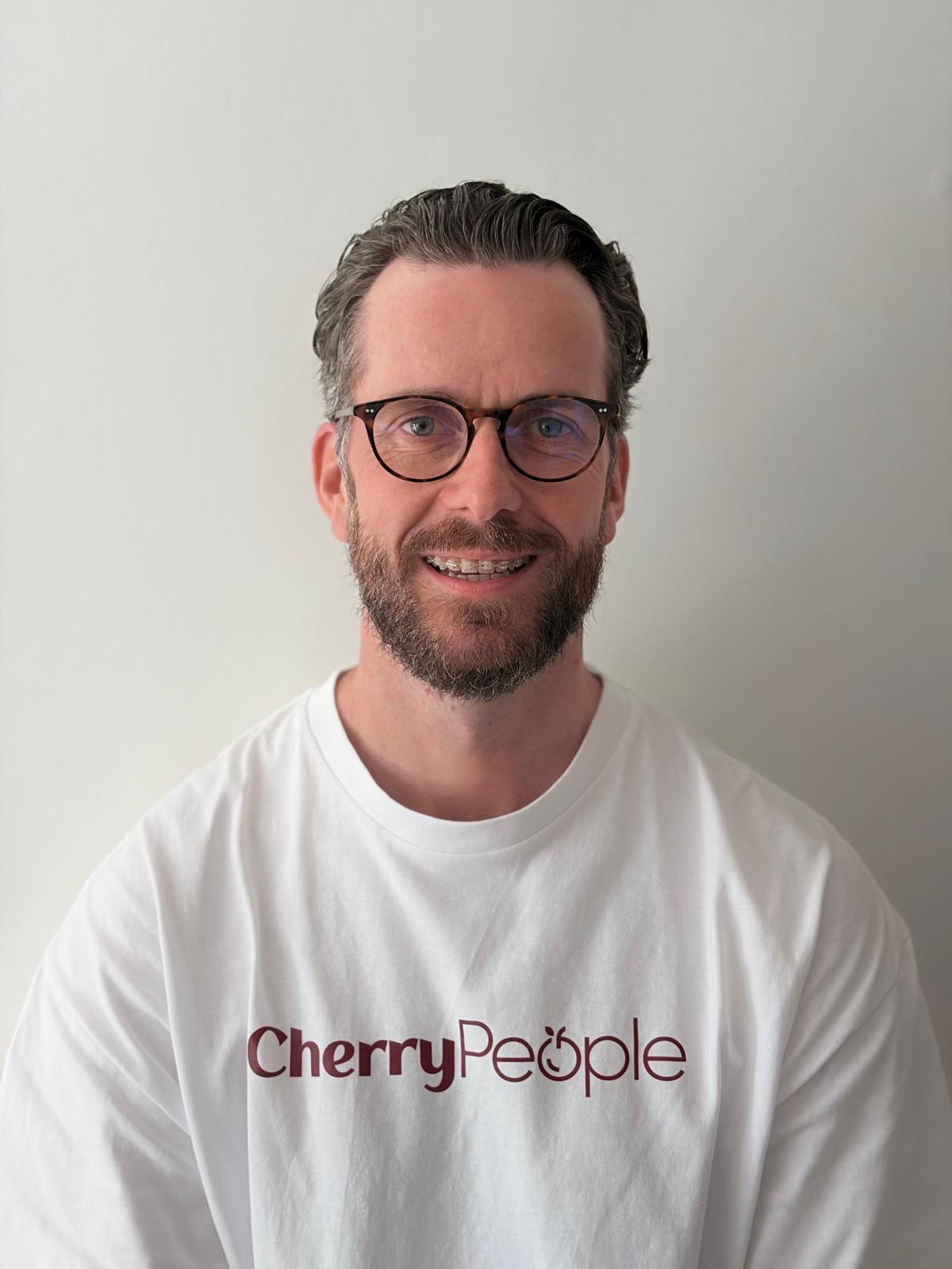 Joe Ryan, founder of CherryPeople, wearing a white CherryPeople T-shirt