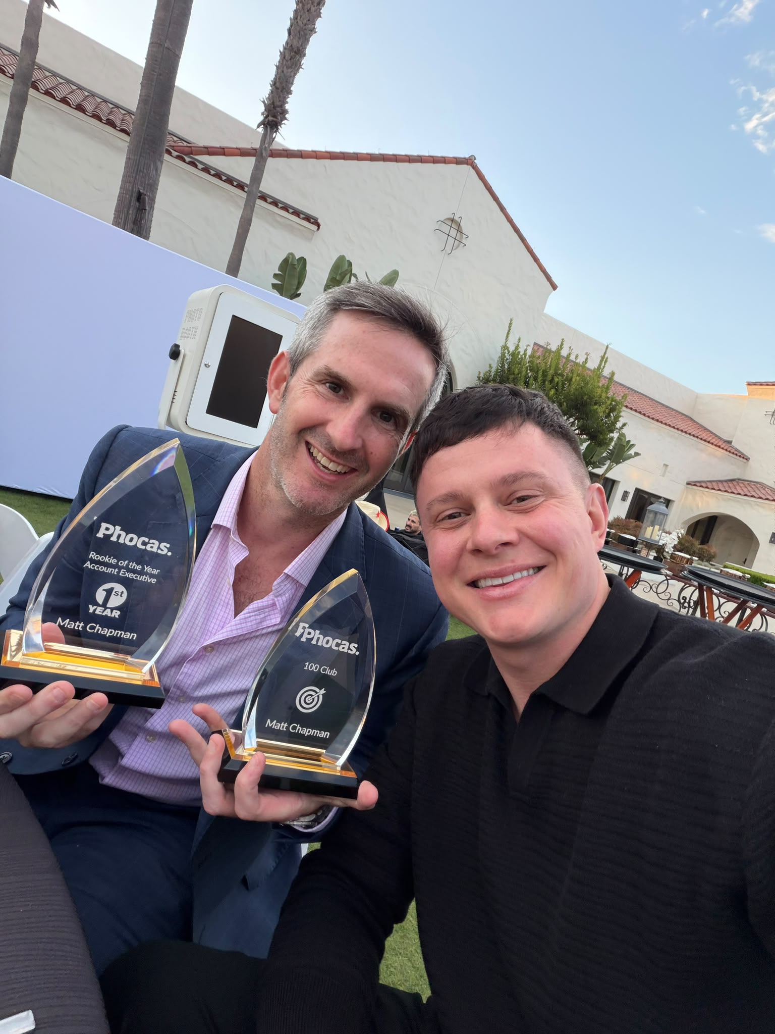 Matt Chapman and Steve Cornwell at the Phocas annual awards, Matt holding his Phocas Rookie of the Year Account Executive trophy and 100 Club trophy.